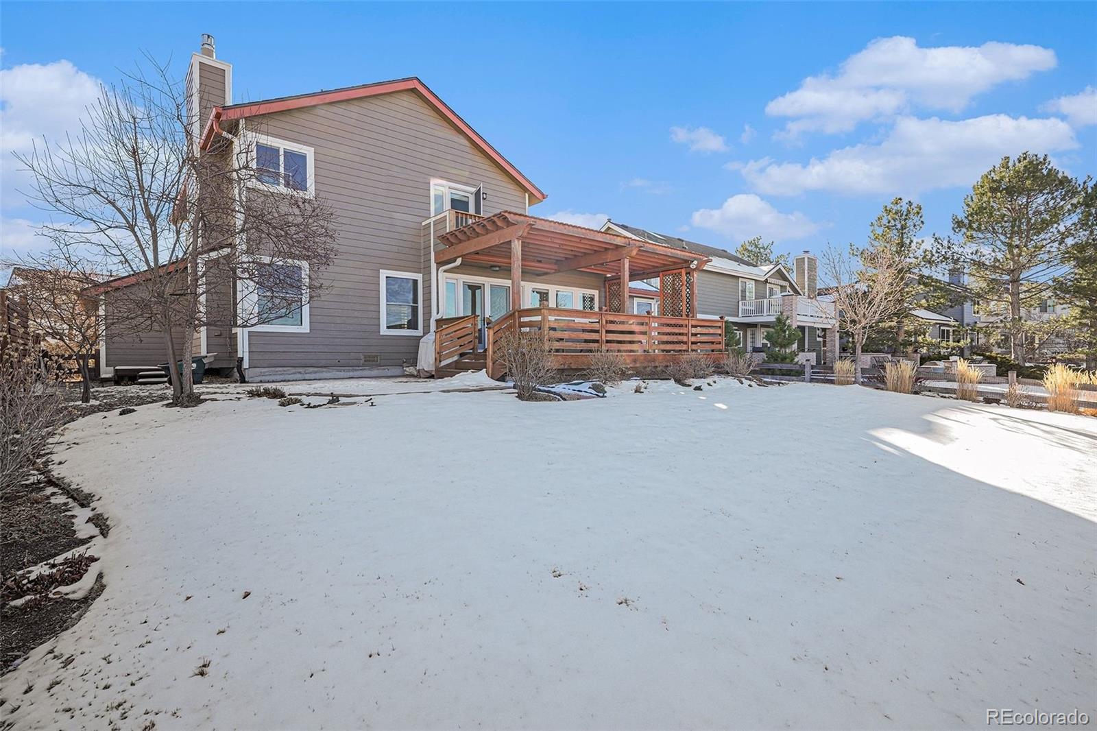 9537 Chesapeake Street Highlands Ranch, CO 80126 - Photo 13 of 34 a view of a house with a snow in the yard