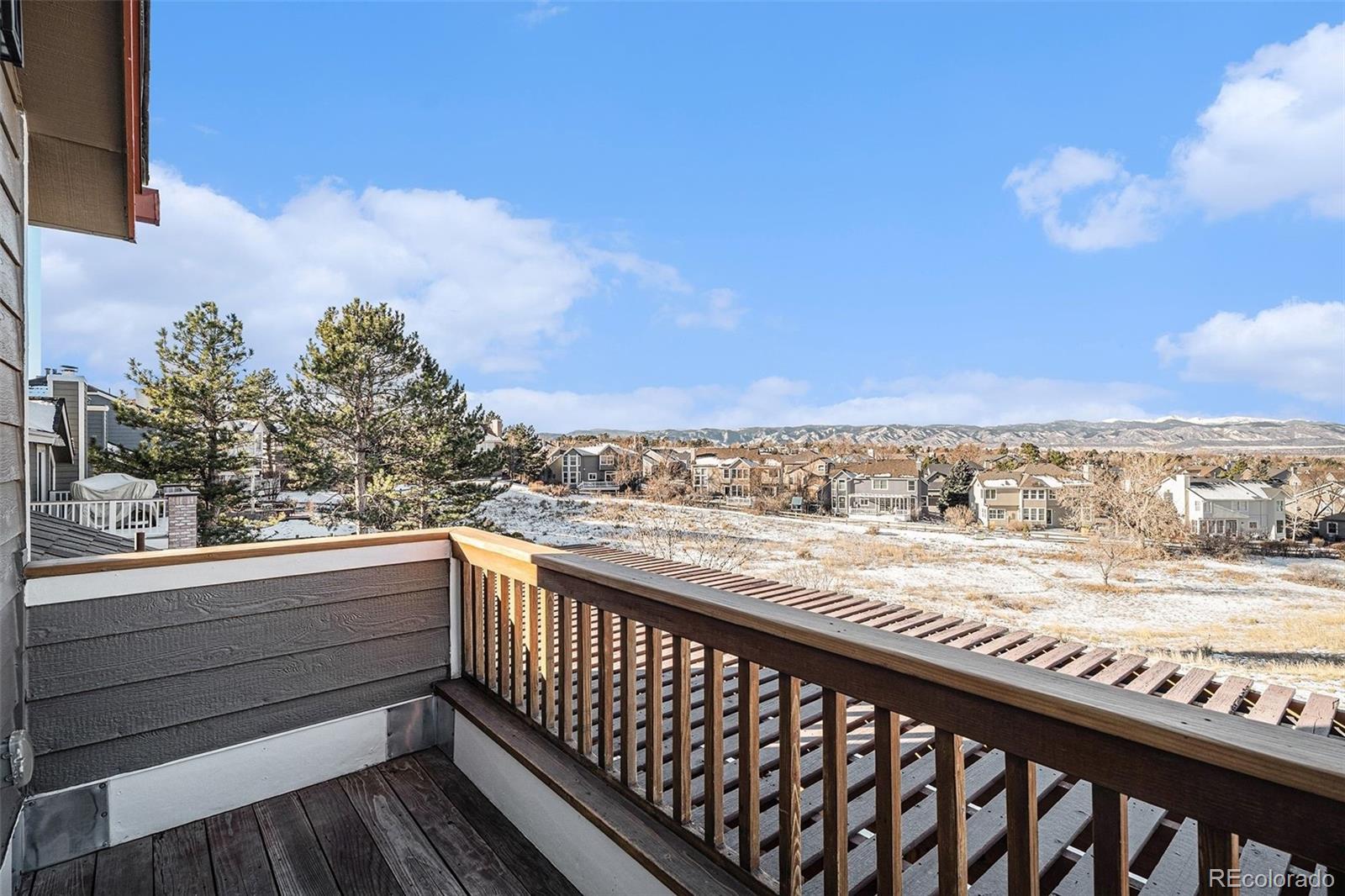 9537 Chesapeake Street Highlands Ranch, CO 80126 - Photo 18 of 34 a view of a balcony with wooden floor and city view