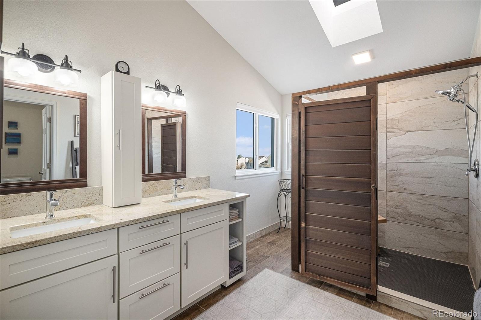 9537 Chesapeake Street Highlands Ranch, CO 80126 - Photo 19 of 34 a bathroom with a double vanity sink and mirror
