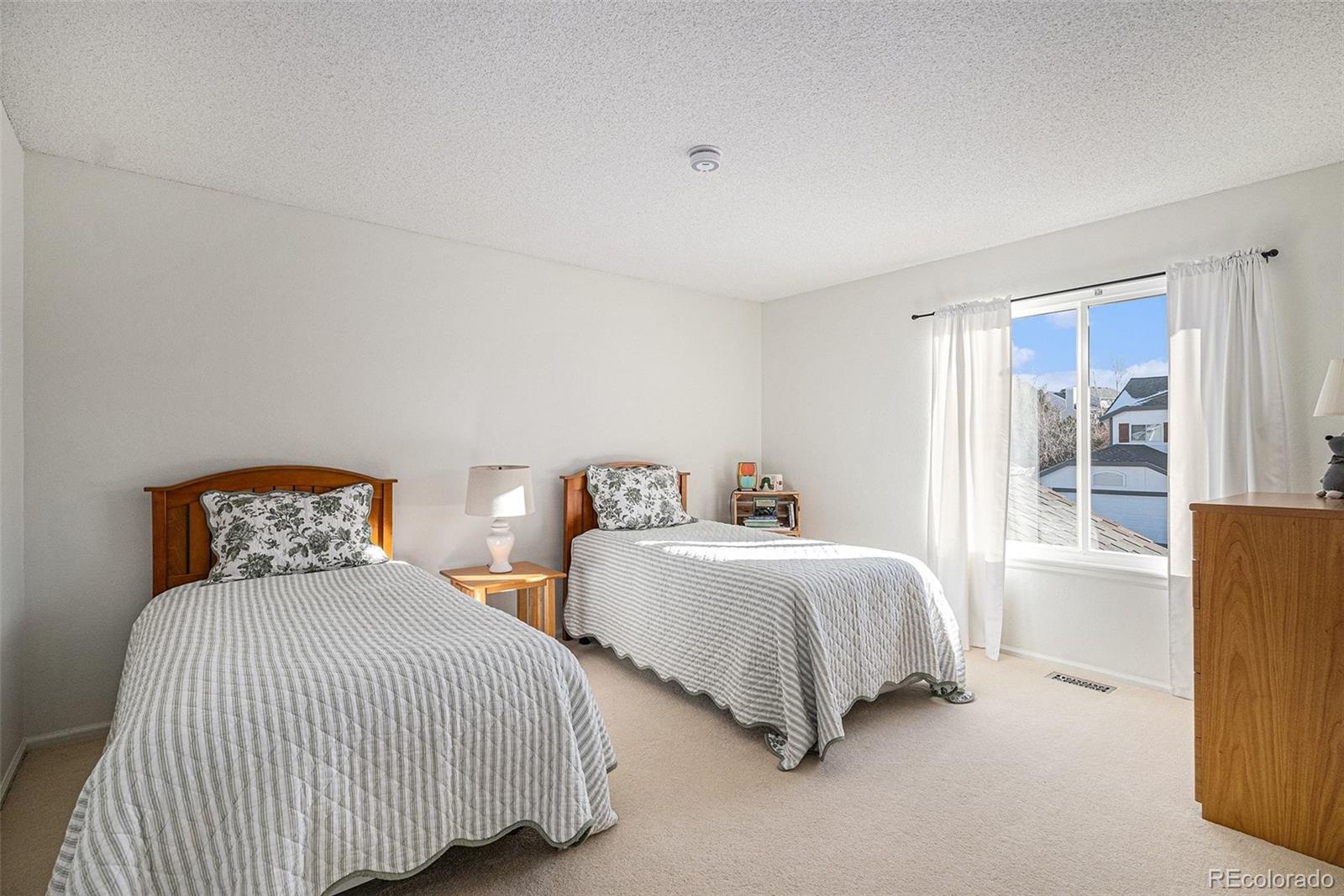 9537 Chesapeake Street Highlands Ranch, CO 80126 - Photo 22 of 34 a bedroom with two beds and next to a window