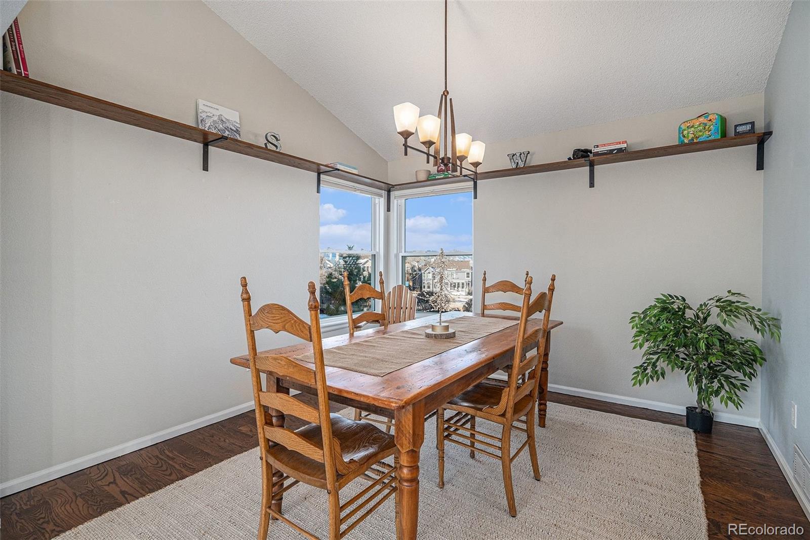 9537 Chesapeake Street Highlands Ranch, CO 80126 - Photo 24 of 34 a view of a dining room with furniture and wooden floor