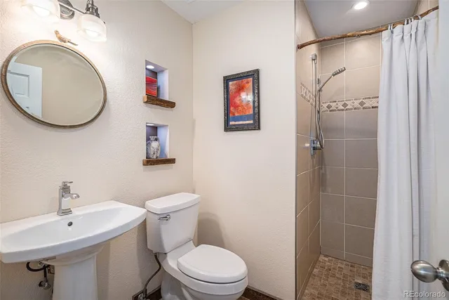 a bathroom with a toilet sink and shower