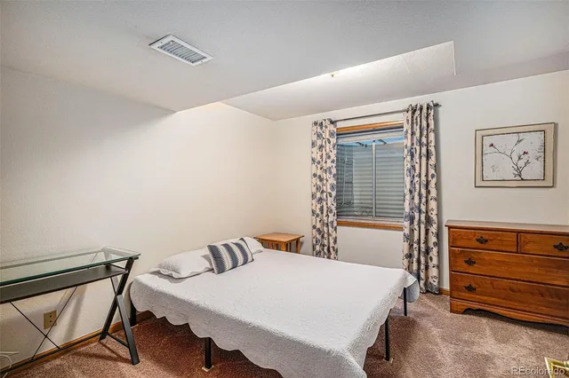 a bed room with a bed and a window