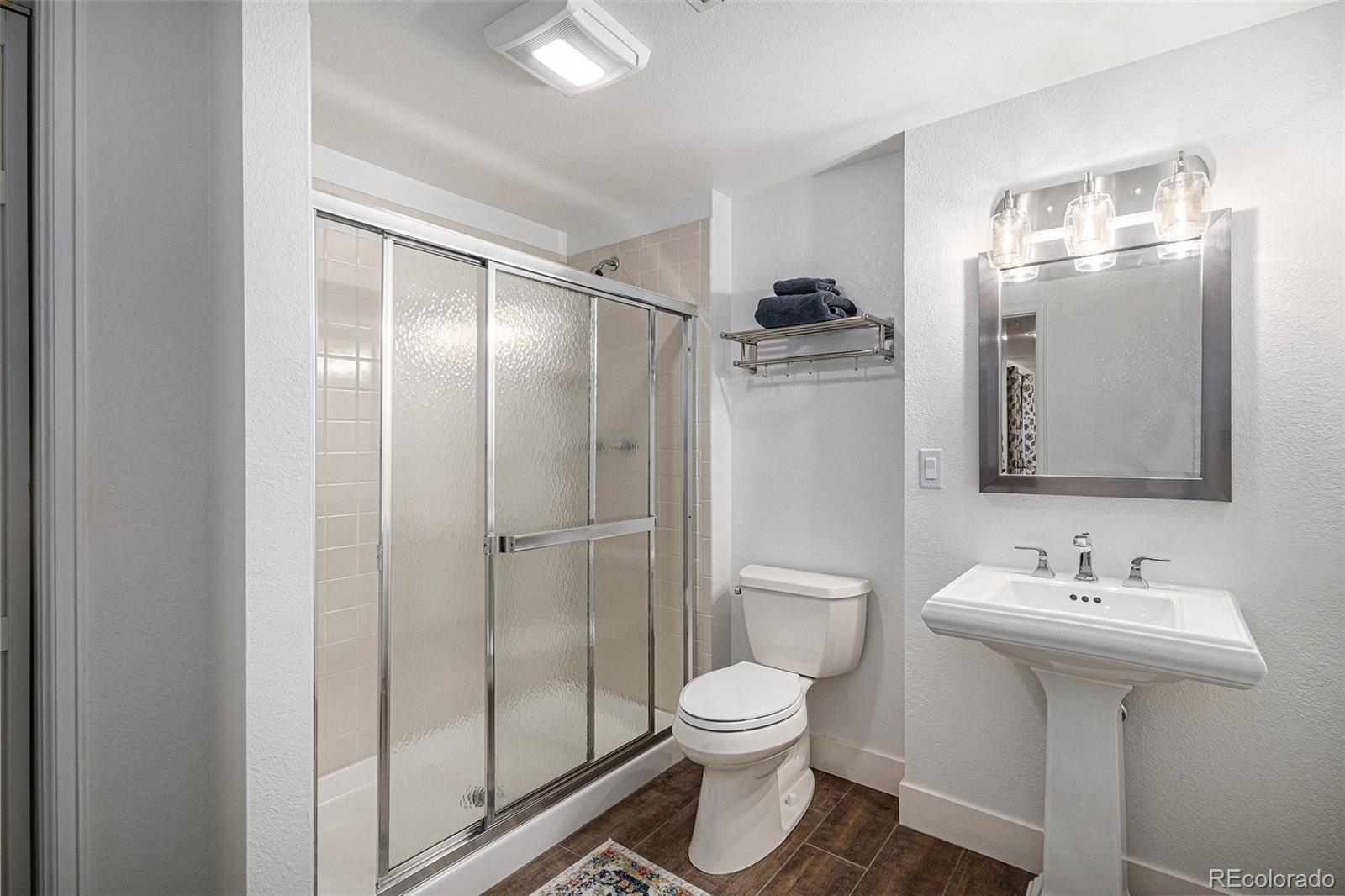 9537 Chesapeake Street Highlands Ranch, CO 80126 - Photo 29 of 34 a bathroom with a toilet sink and shower