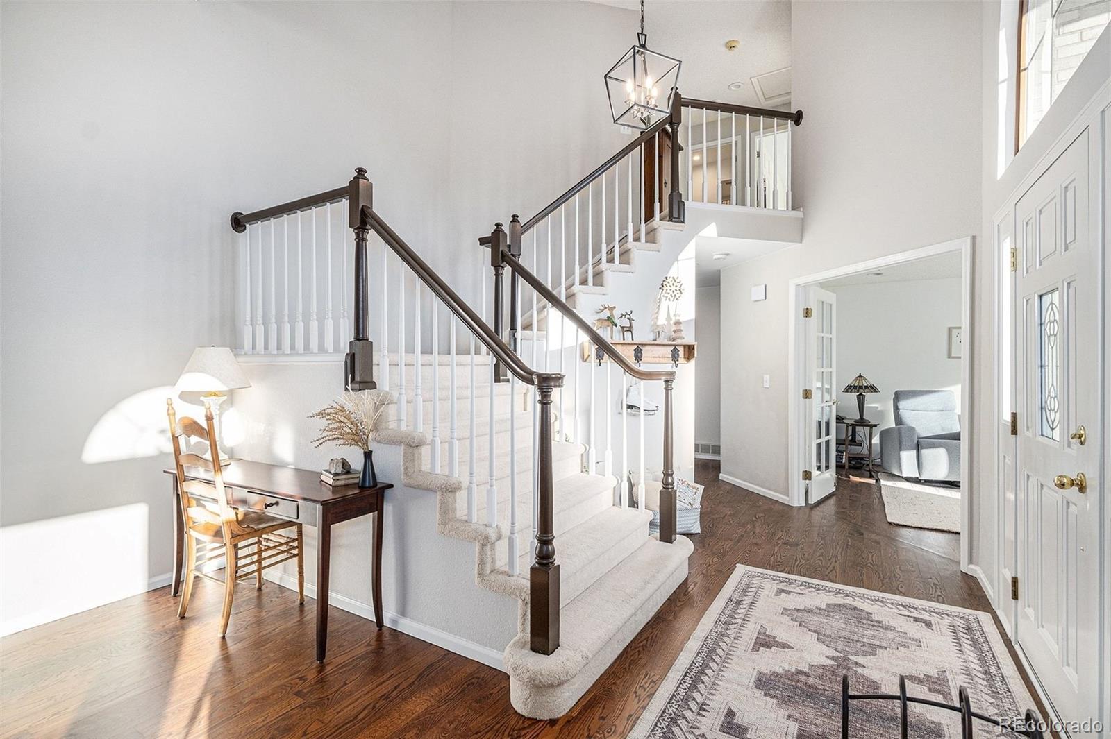 9537 Chesapeake Street Highlands Ranch, CO 80126 - Photo 4 of 34 a view of entryway dining room and hall with wooden floor