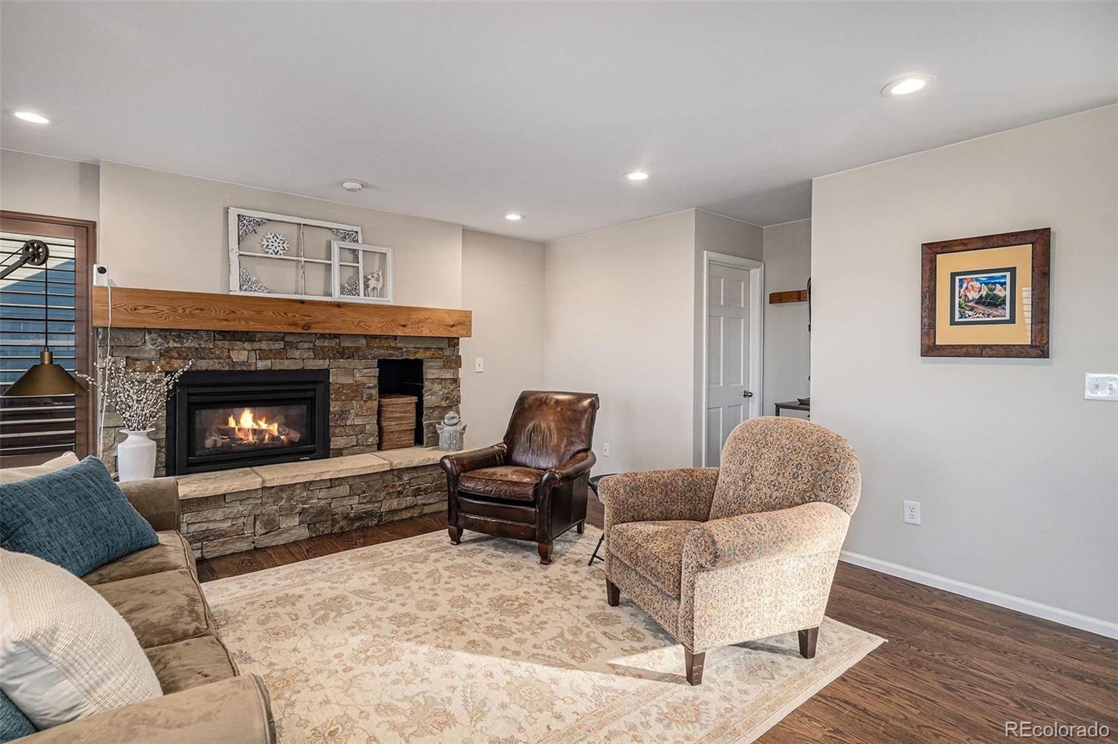 9537 Chesapeake Street Highlands Ranch, CO 80126 - Photo 9 of 34 a living room with furniture and a fireplace