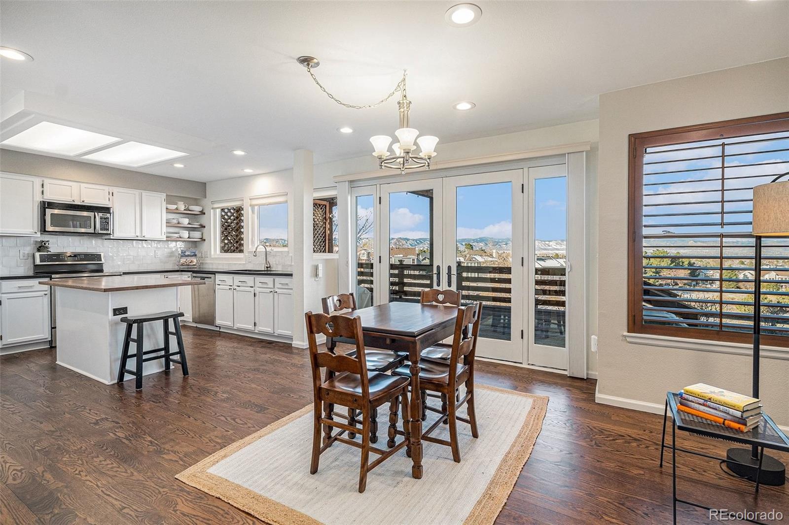 9537 Chesapeake Street Highlands Ranch, CO 80126 - Photo 10 of 34 a view of a dining room with furniture window and wooden floor