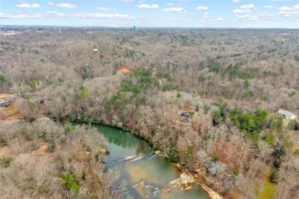 a view of a lake in middle of forest