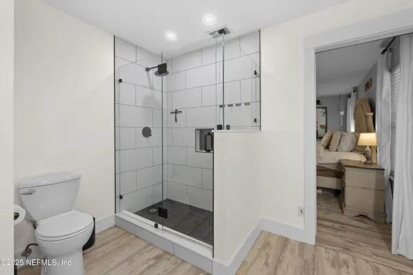 a bathroom with a shower a toilet and a sink