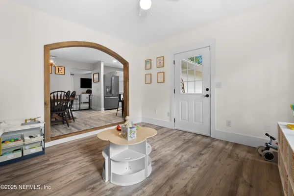 a living room with furniture and wooden floor