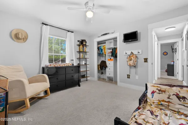a bedroom with furniture and a window