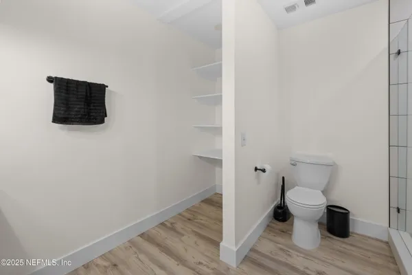 a bathroom with a toilet and a shower