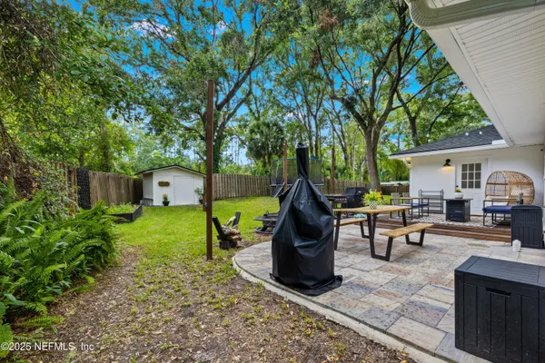 a view of a house with backyard porch and sitting area