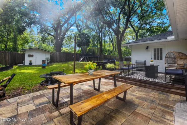 a view of a backyard with sitting area