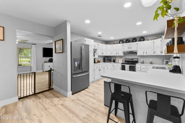 a kitchen with stainless steel appliances a refrigerator and a stove top oven