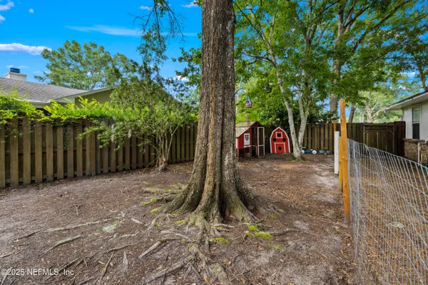 a sign board with yard and wooden fence