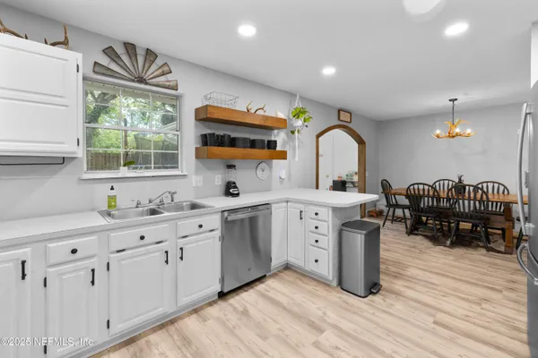 a kitchen with sink cabinets and wooden floor