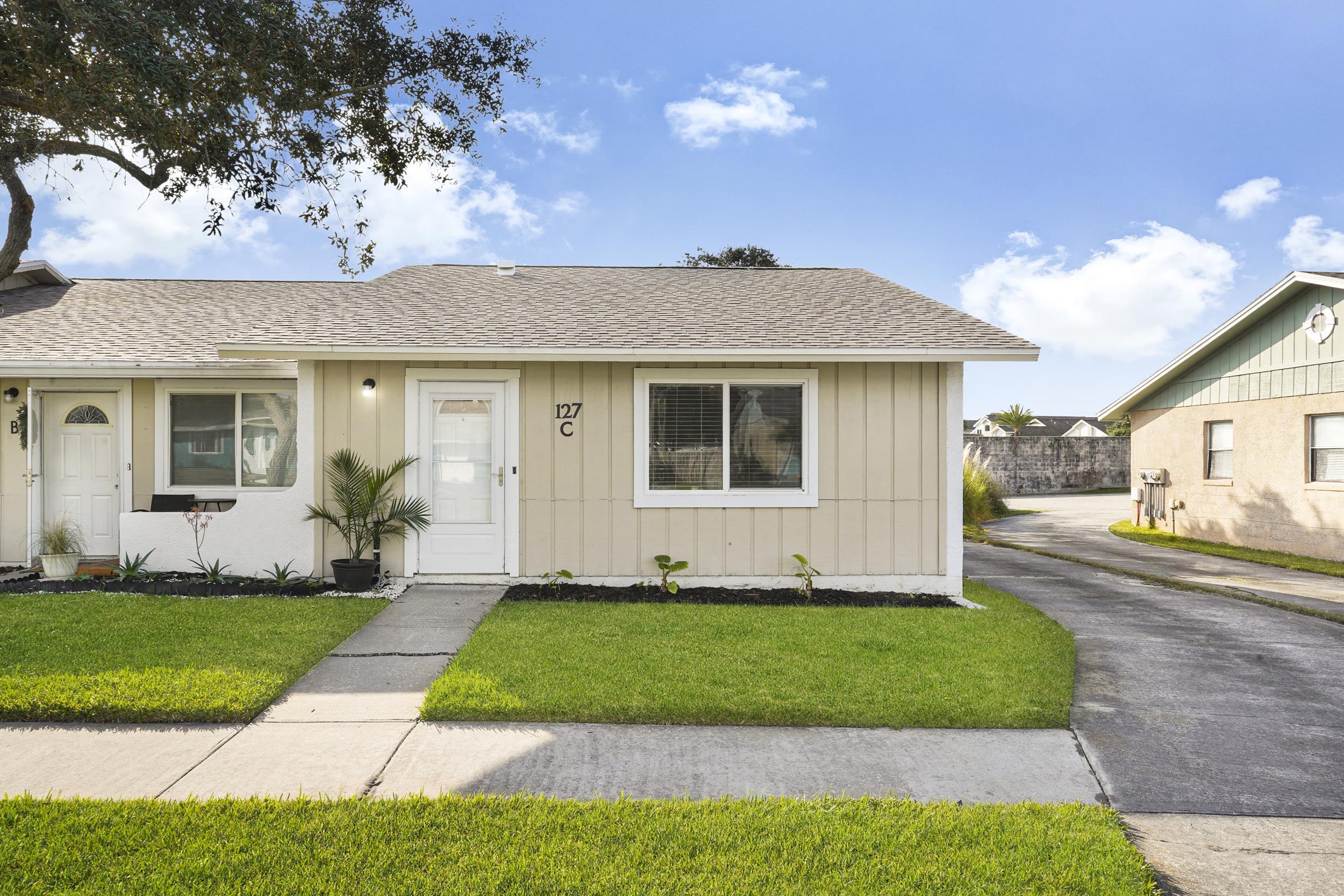 Bungalow with roof with shingles and a front lawn