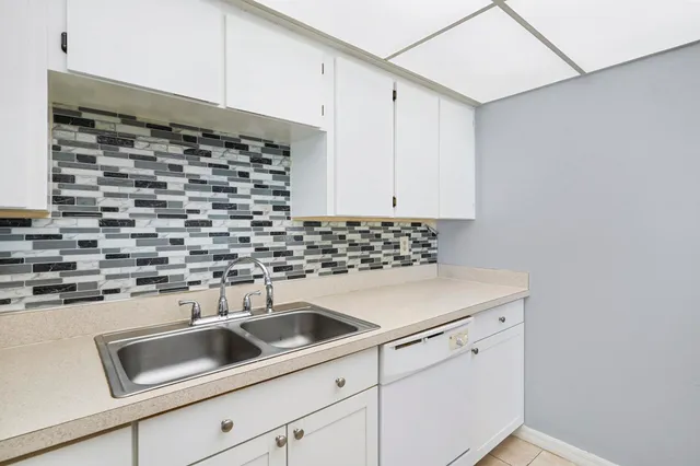 a kitchen with a sink and cabinets