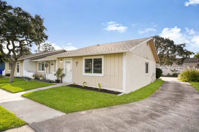 a front view of a house with a yard and porch