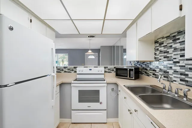 a kitchen with a sink a stove and washer