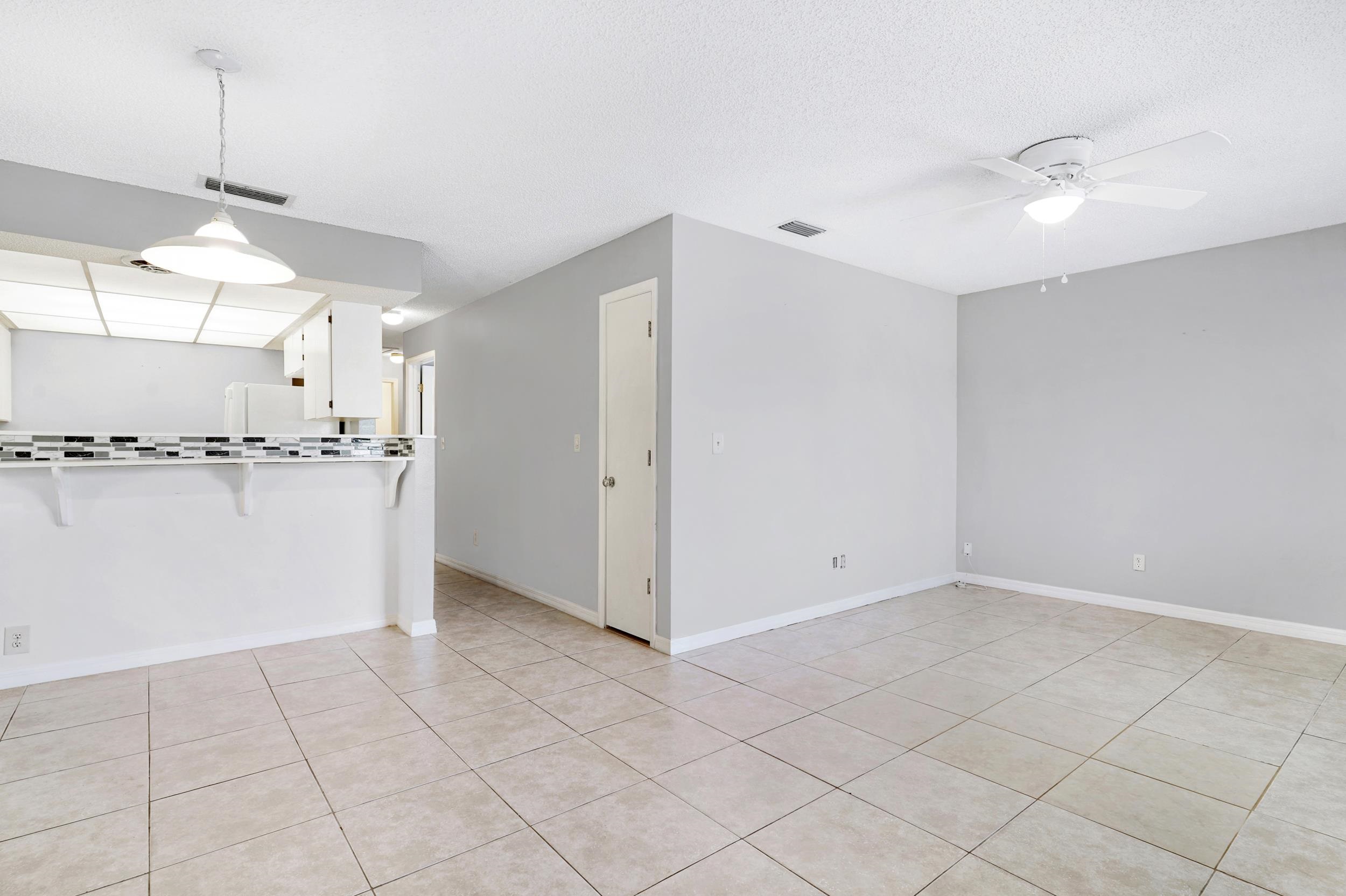 127 Rio Del Mar Street, Unit C St. Augustine, FL 32080 - Photo 10 of 29 a view of a kitchen with a sink and dishwasher a refrigerator with white cabinets