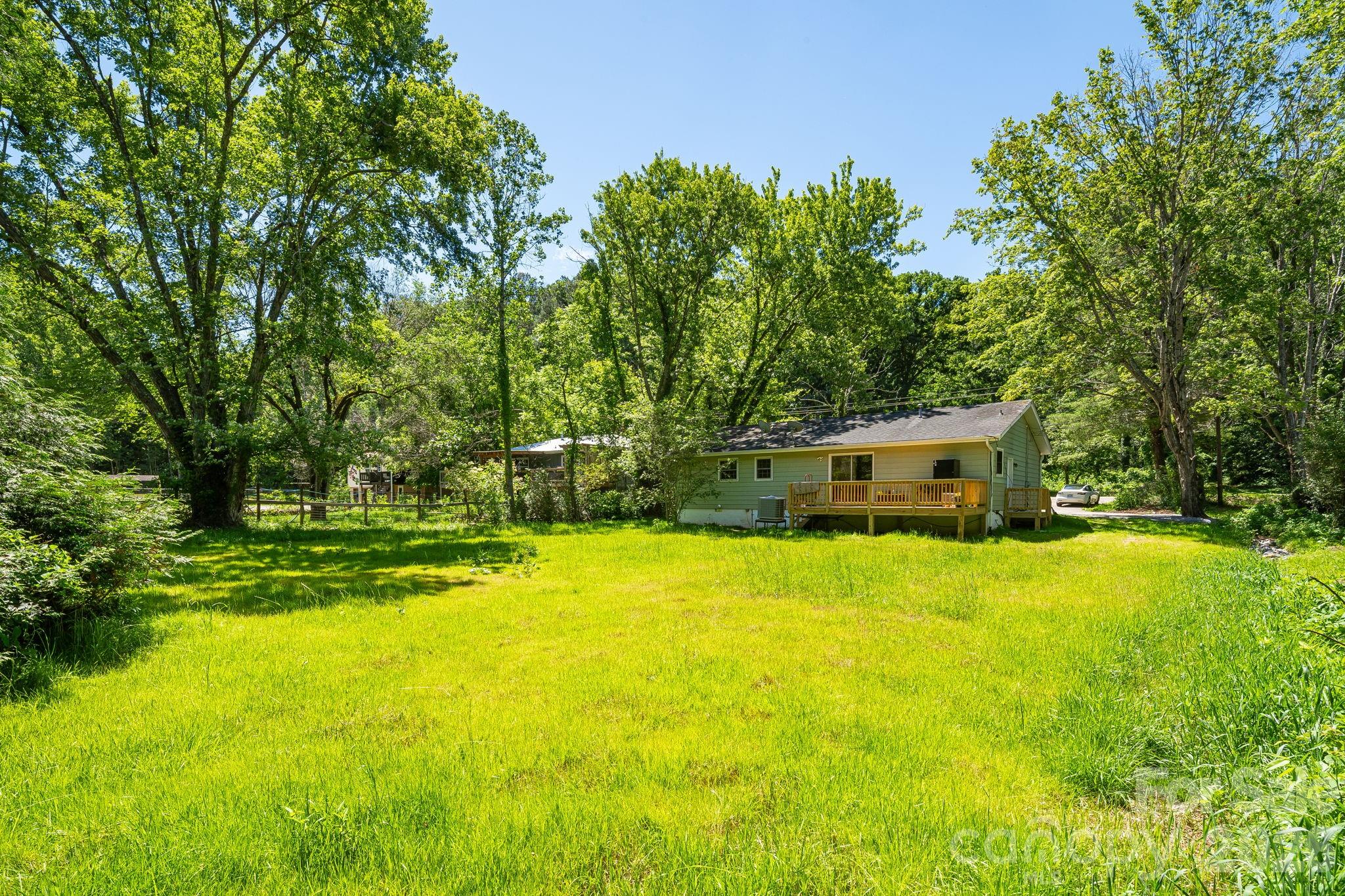 468 Beaverdam Road Asheville, NC 28804 - Photo 5 of 19 a view of a house with pool and a yard