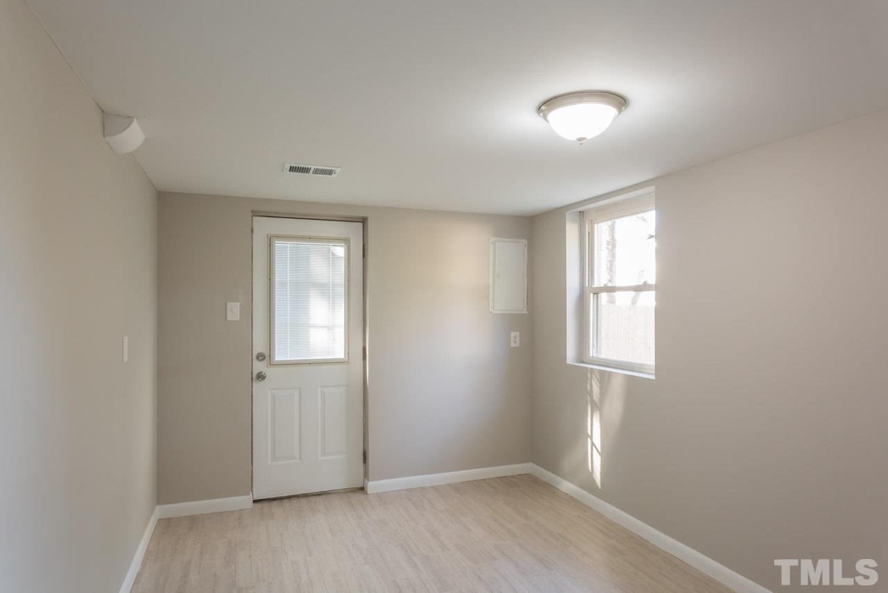 1012 Weston Street Raleigh, NC 27610 - Photo 17 of 23 an empty room with wooden floor and windows