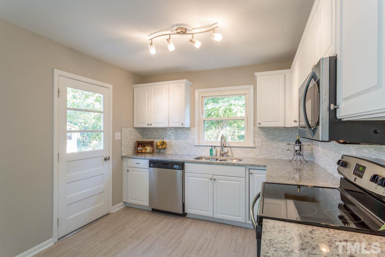 1012 Weston Street Raleigh, NC 27610 - Photo 3 of 23 a kitchen with a sink appliances cabinets and a window
