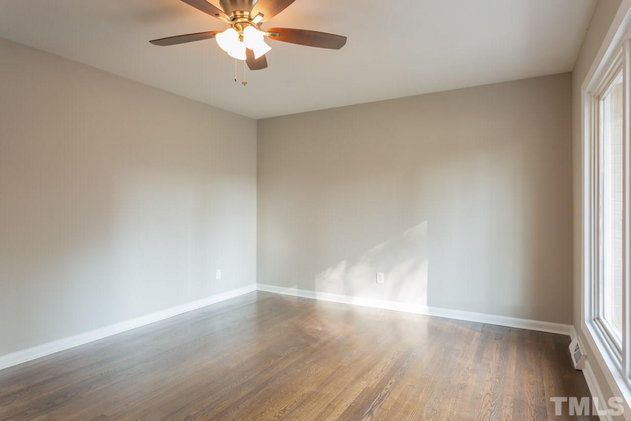 1012 Weston Street Raleigh, NC 27610 - Photo 7 of 23 wooden floor in an empty room with a window