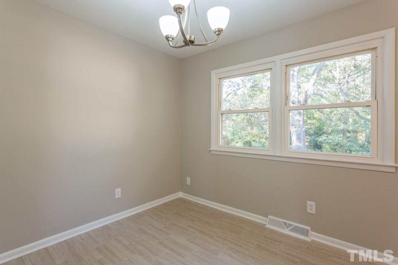 1012 Weston Street Raleigh, NC 27610 - Photo 8 of 23 wooden floor in an empty room with a window