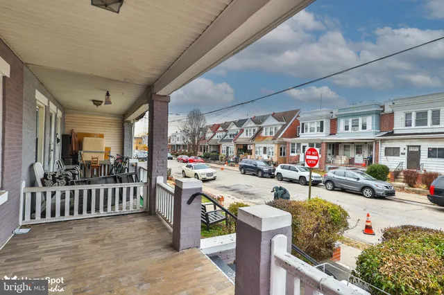 a living room with furniture a fireplace and a chandelier