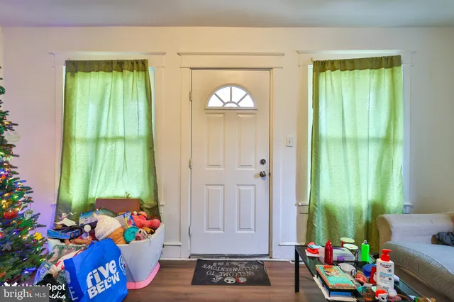 a living room with furniture a fireplace and gym equipment