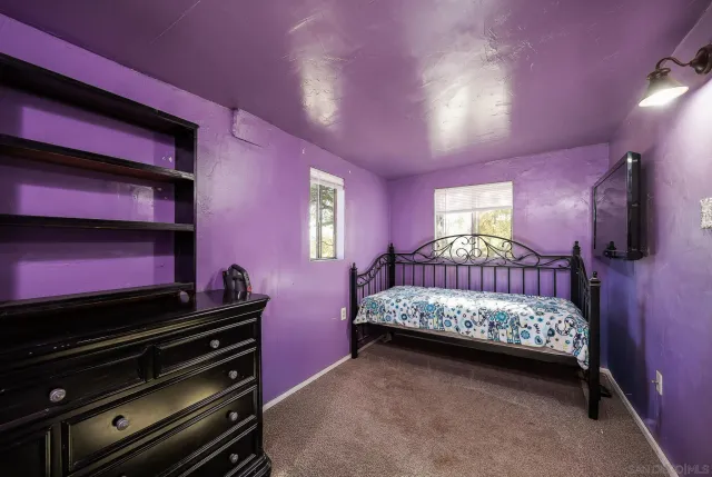 a view of a wooden house with a wooden fence and a bench