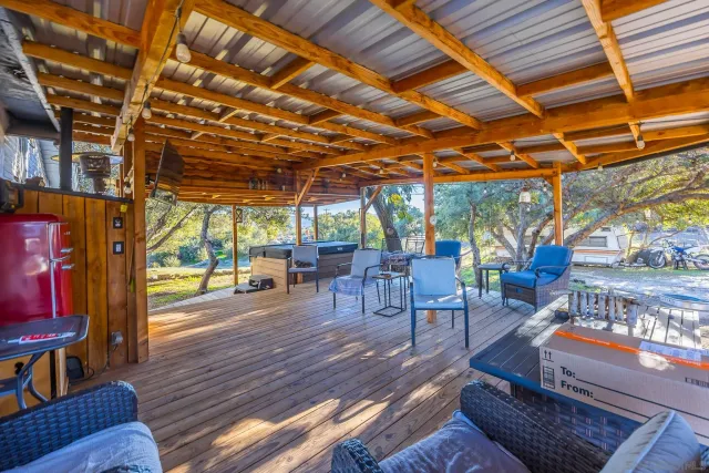 a view of a porch with furniture and wooden floors