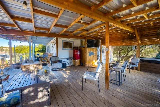 a living room with furniture kitchen view and a window