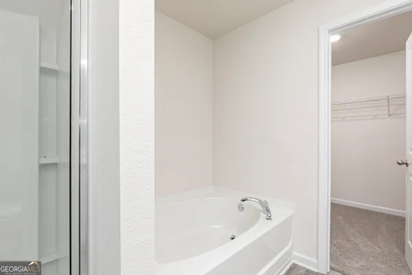 a white bath tub sitting next to a white sink