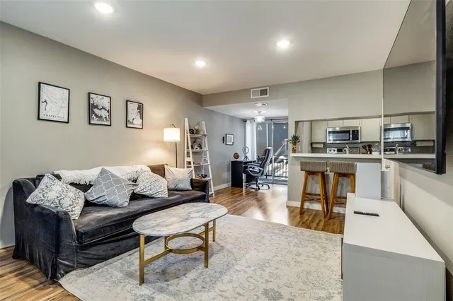 a living room with furniture and kitchen view