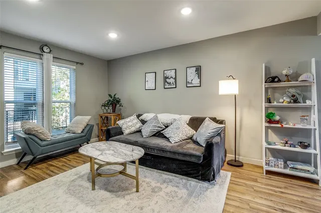 a living room with furniture and a wooden floor