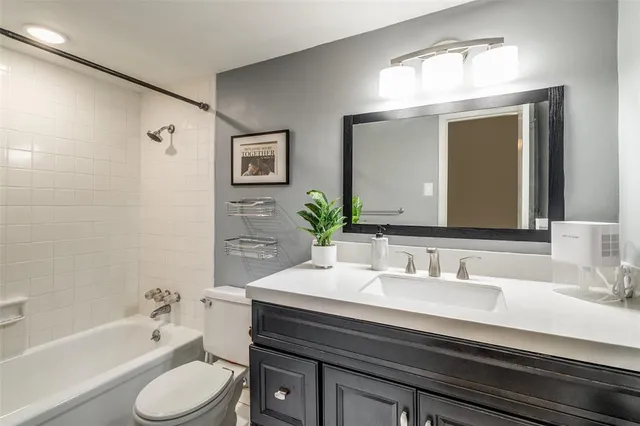 a bathroom with a sink a toilet and bathtub