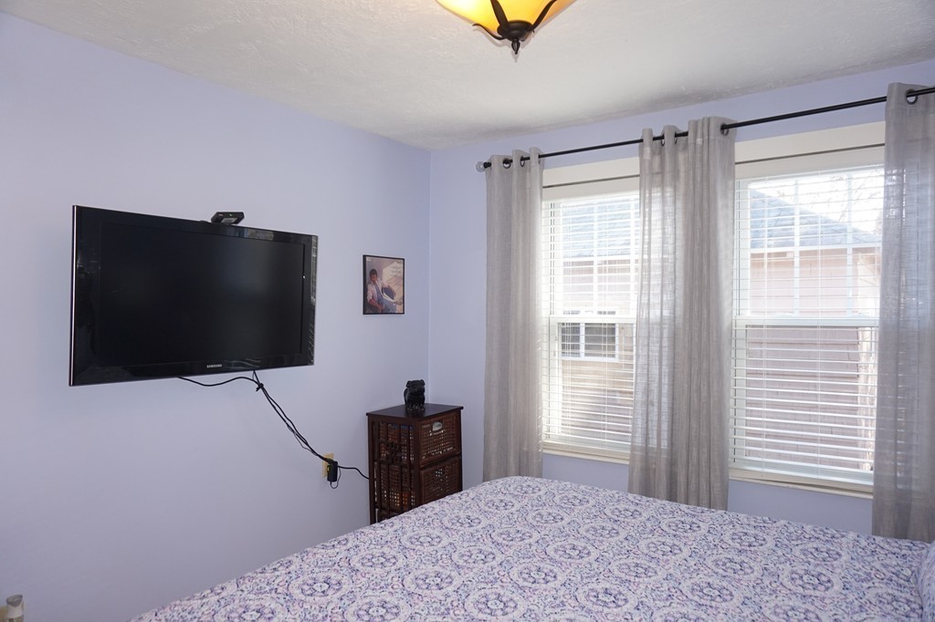 329 Mill Street Lancaster, MA 01523 - Photo 18 of 30 a bedroom with a bed and a flat screen tv
