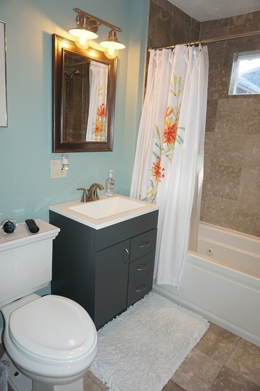 329 Mill Street Lancaster, MA 01523 - Photo 19 of 30 a bathroom with a toilet sink and mirror