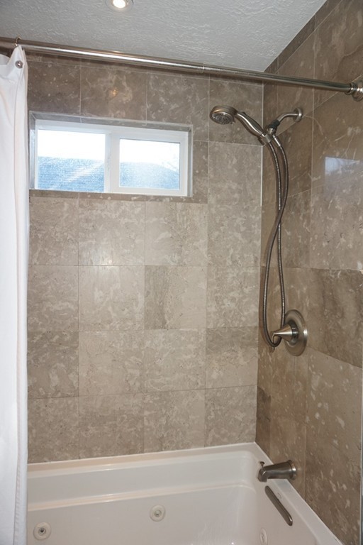 329 Mill Street Lancaster, MA 01523 - Photo 20 of 30 a bathroom with a shower and a bath tub