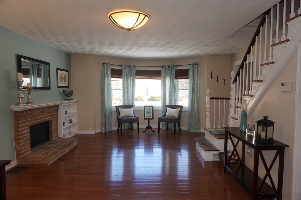 329 Mill Street Lancaster, MA 01523 - Photo 2 of 30 a view of a livingroom with furniture and a fireplace