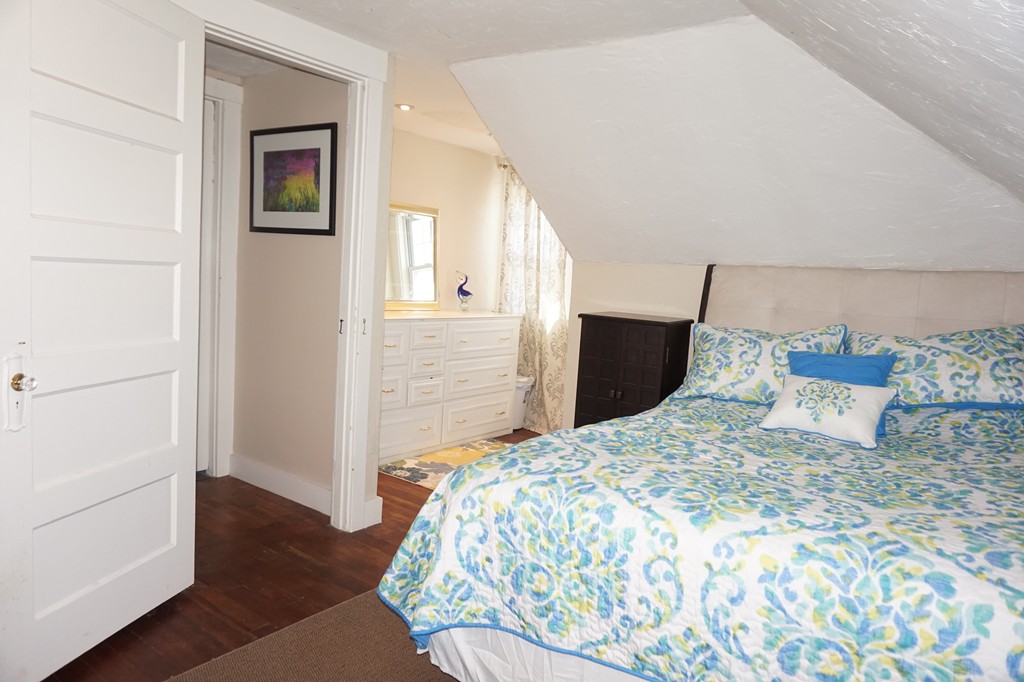 329 Mill Street Lancaster, MA 01523 - Photo 21 of 30 a bedroom with a bed and a walk in closet