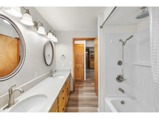 a bathroom with a tub sink and mirror