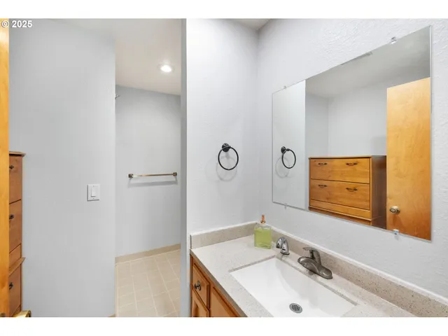 a bathroom with a sink vanity granite and a mirror