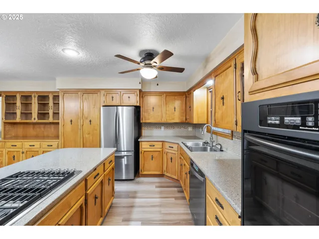 a kitchen with a stove a refrigerator and a sink