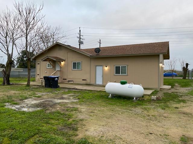 15792 Raymond Road Madera, CA 93638 - Photo 16 of 18 a front view of a house with a garden and plants