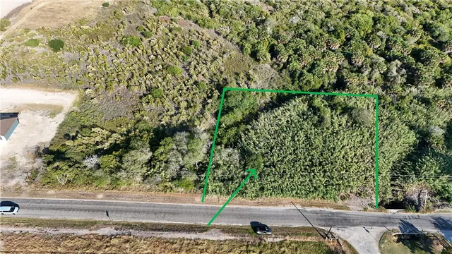 an aerial view of a residential houses with yard